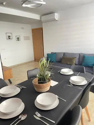 a black table with white plates and silverware on it at UIM Mediterraneo PB Felipe 1 Wifi in Puerto de Sagunto
