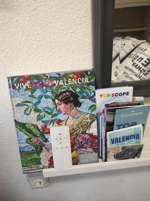 a shelf with books and a wii controller on it at Comoda y moderna HABITACION DOBLE in Valencia