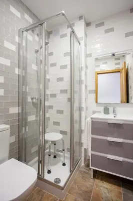 a bathroom with a shower and a stool next to a sink at Casa rural Torre Buena Vista a 40 minutos de Valencia con gran jacuzzi y vistas maravillosass in Benafer