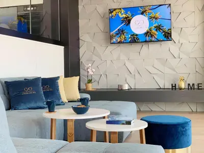 a living room with a couch and two tables at Colina del Sol Cullera - Villa Sol in Cullera