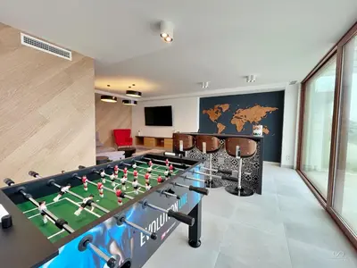 a living room with a foosball table in a room at Colina del Sol Cullera - Villa Sol in Cullera