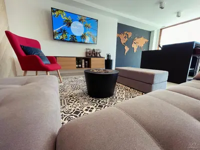 a living room with a couch and a chair at Colina del Sol Cullera - Villa Sol in Cullera