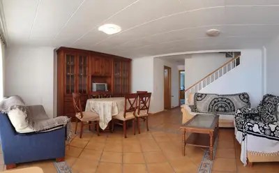 a living room with a table and chairs at Vacansis Adosado Marenyet in Cullera