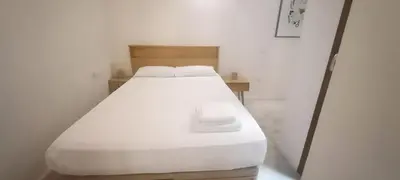 a white bed in a white room with at Acogedor piso en el corazon del Casco Historico in Valencia