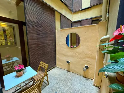 a small patio with a table and chairs and a mirror at Acogedor piso en el corazon del Casco Historico in Valencia