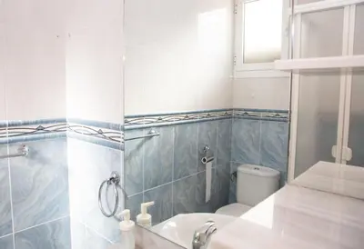 a bathroom with a toilet and a sink at Summer Beach House in Puebla de Farnals