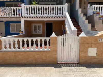 a house with a white fence and a staircase at Summer Beach House in Puebla de Farnals