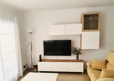 a living room with a tv and a couch at Summer Beach House in Puebla de Farnals