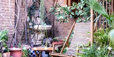 a patio with a staircase and a table and chairs at Palau de Vic in Valencia