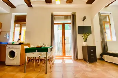 a kitchen with a table and chairs in a room at Acogedor apartamento centro histórico Valencia in Valencia