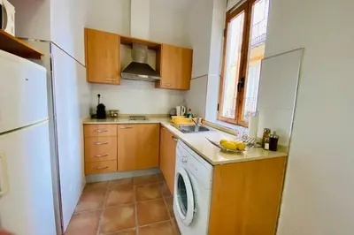 a kitchen with a washing machine and a washer at Acogedor loft en centro histórico in Valencia