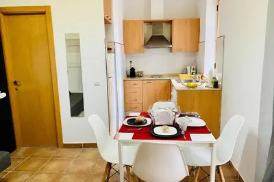 a kitchen with a white table and white chairs at Acogedor loft en centro histórico in Valencia