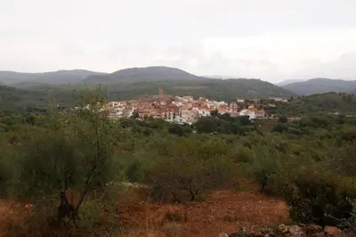 a town in the middle of a field with mountains at La Casa de Piedra, una ventana al paraíso in Matet