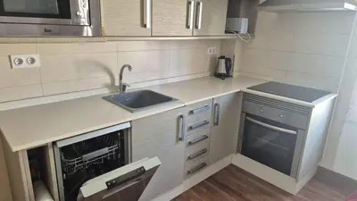 a small kitchen with a sink and a dishwasher at Luxury Apartments Puerto Valencia in Valencia