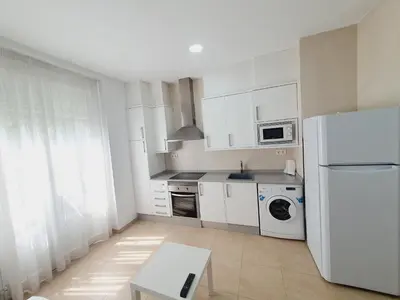 a kitchen with white appliances and a white refrigerator at Luxury Apartments Puerto Valencia in Valencia