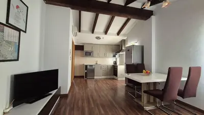 a kitchen and living room with a table and chairs at Luxury Apartments Puerto Valencia in Valencia