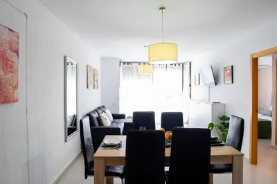 a dining room with a table and chairs at FLORIT FLATS - The Malvarrosa Beach Apartment & Free Parking in Valencia