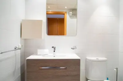 a bathroom with a sink and a toilet at FLORIT FLATS - The Malvarrosa Beach Apartment & Free Parking in Valencia