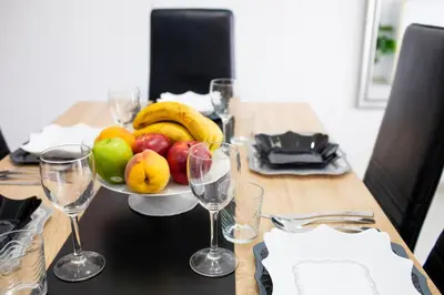 a table with a bowl of fruit and wine glasses at FLORIT FLATS - The Malvarrosa Beach Apartment & Free Parking in Valencia