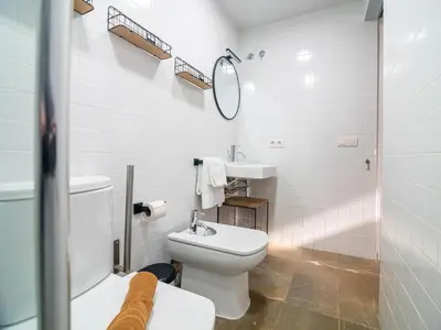 a bathroom with a toilet and a sink and a mirror at MD Vitoria City Center in Valencia