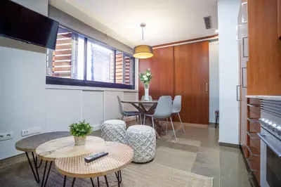 a living room with a table and a dining room at MD Vitoria City Center in Valencia