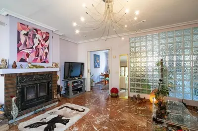 a living room with a fireplace and a television at Palau 2 in Valencia