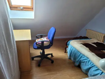 a bedroom with a blue chair next to a bed at Palau 2 in Valencia