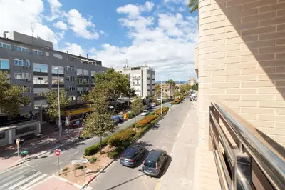 a view of a city with cars parked on a street at Global Vacacional, Apartamento a 200m de la playa de Puerto de Sagunto in Puerto de Sagunto
