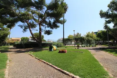 a park with a ball on the grass at Global Vacacional, Apartamento con terraza y piscina a un paso de la playa in Canet de Berenguer
