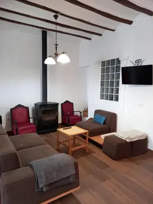 a living room with a couch and a fireplace at La Gata Mala in Navarrés