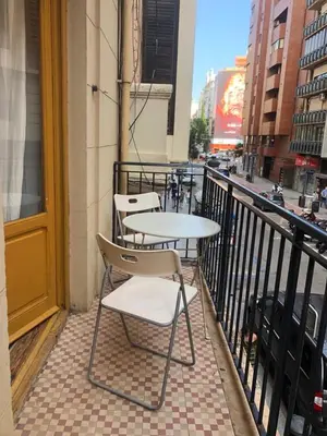 three tables and chairs on a balcony with a street at Acogedor apartamento en Ruzafa-centro in Valencia