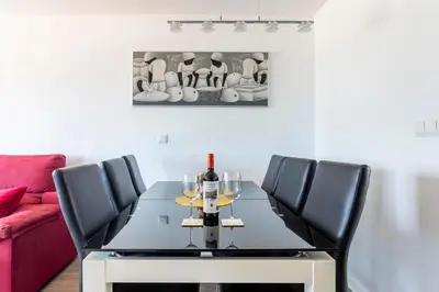 a dining room with a table with wine glasses at Fantástico Apartamento en Primerísima Línea Playa in La Torre