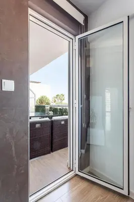 a sliding glass door leading to a balcony at Fantástico Apartamento en Primerísima Línea Playa in La Torre