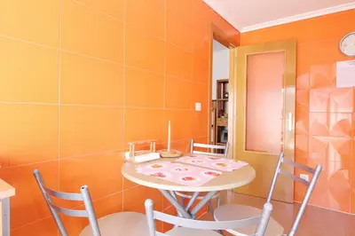 a dining room with a table and chairs at Global Vacacional, Ático con 2 terrazas en la playa Puerto de Sagunto in Puerto de Sagunto