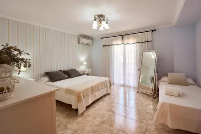 a bedroom with two beds and a mirror in it at Casa Rural 