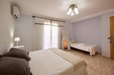 a bedroom with a bed and a mirror and a window at Casa Rural 