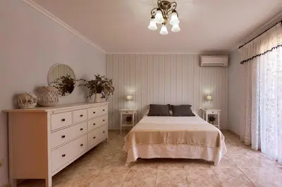 a bedroom with a bed and a dresser and a mirror at Casa Rural 