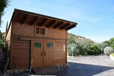a small wooden shed with a door in a driveway at Casa Rural 
