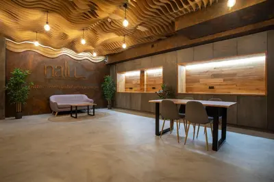 a lobby with a table and chairs and a bench at NALU Valencia Boutique Rooms in Valencia