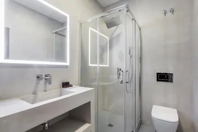 a bathroom with a shower and a toilet and a sink at NALU Valencia Boutique Rooms in Valencia