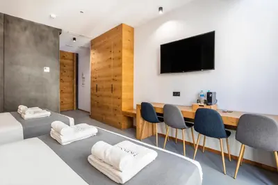 a room with two beds and a table with chairs at NALU Valencia Boutique Rooms in Valencia