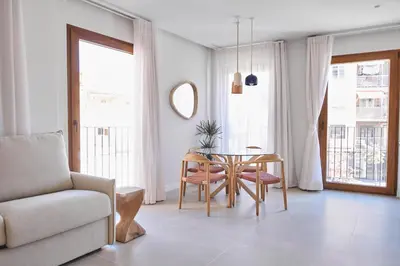 a living room with a table and a chair at Slow Home Apartments in Valencia