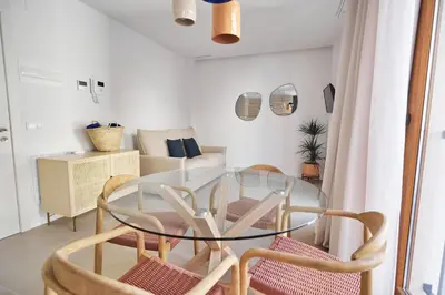 a dining room with a glass table and chairs at Slow Home Apartments in Valencia