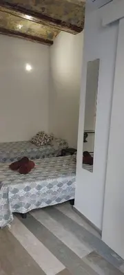 a bedroom with a bed in a room with a mirror at SERRANO Home in Valencia