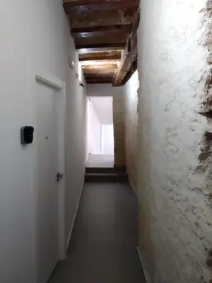 a hallway with white walls and a white door at SERRANO Home in Valencia
