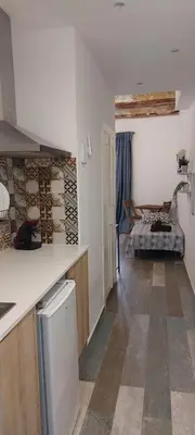 a kitchen with a counter and a living room at SERRANO Home in Valencia