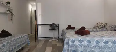 a room with two beds and a television in it at SERRANO Home in Valencia