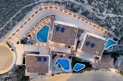 an aerial view of a resort with a pool and chairs at Colina del Sol Cullera - Villa Luna in Cullera