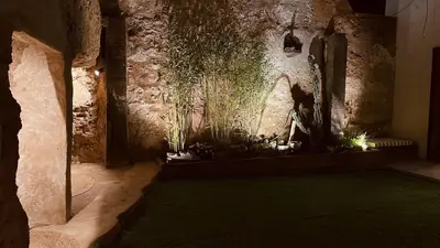 a room with a stone wall with plants on it at Casa Rural La Cabrentà in Estubeny