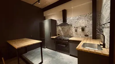 a kitchen with a stainless steel refrigerator and a sink at Casa Rural La Cabrentà in Estubeny